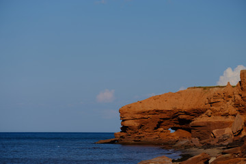 Naklejka premium Erosion of the cliffs along the red cliffs of North Rustico and Green Gables on the Gulf of St Lawrence