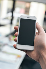 Hand hold mobile phone, person using smartphone. Top view closeup on black screen digital device mock up. Marketing technology design surface background, communication lifestyle