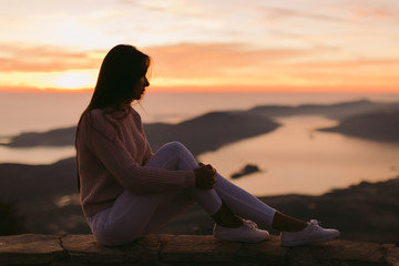 woman dreaming at sunset with mountains view