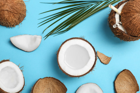 Coconut water and fresh nuts on color background