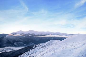 Snowy landscape with mountains on winter day