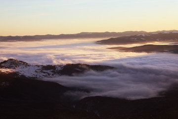 Fototapeta premium Beautiful landscape with foggy mountains in wintertime