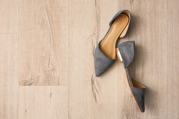 Pair of female shoes on floor