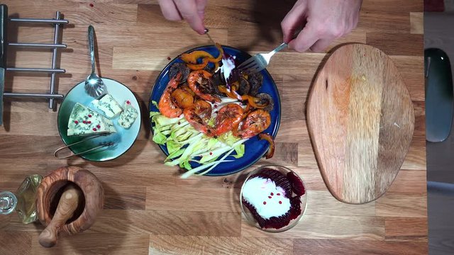 Top view prepare serving plate with shrimps, andive, beet salad and moldy cheese.