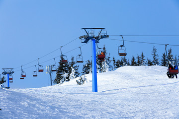 Ski lift at snowy resort. Winter vacation