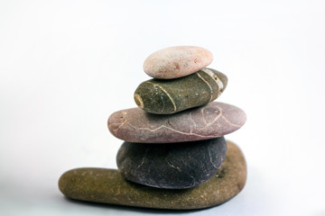 Fototapeta na wymiar stack of stones on neutral background