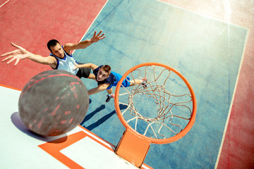 High angle view of basketball player dunking basketball in hoop