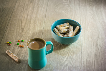 A simple snack of cocoa and cookies on wooden background