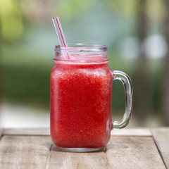 Fresh organic watermelon smoothie in glass mug , close up