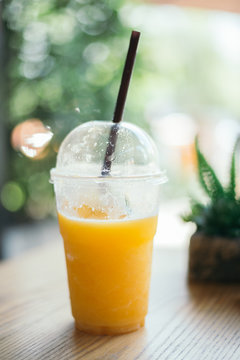 Orange juice smoothie glass on wood table