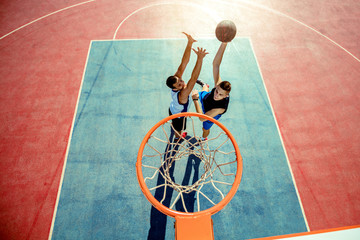 High angle view of basketball player dunking basketball in hoop