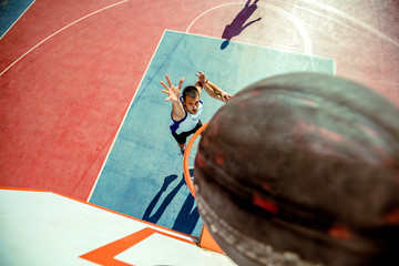 High angle view of basketball player dunking basketball in hoop