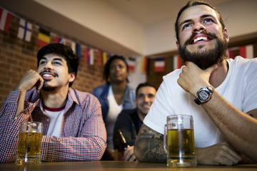 Frieds cheering sport at bar together