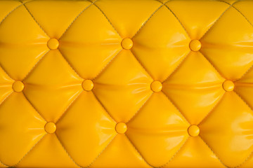 Close up yellow retro chesterfield style, capitone textile background