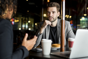 Business partners working together at a cafe