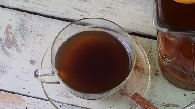 Black tea, manual squeezer with lemons. A jug of black tea and cubes of sugar.