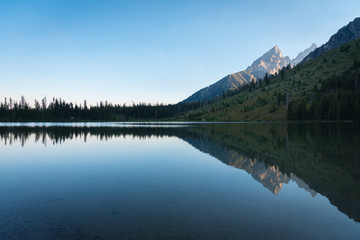 Naklejka na ściany i meble Peaceful reflection on lake