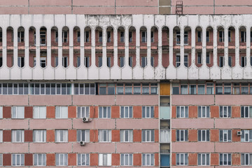 Cylinder shapes of a soviet era building in red and  white brick