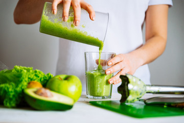 woman transfuse smoothie to glass. healthy food concept