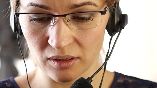 businesswoman talking on a headset in an office. customer service proffessional. 4K