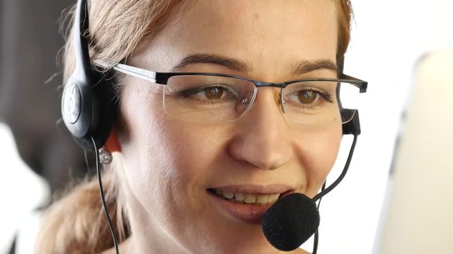 businesswoman talking on a headset in an office. customer service proffessional. 4K