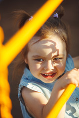 cute little child playing on playground.