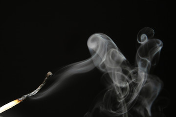 extinguished match with smoke
