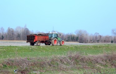 tractor with a cart full of manure