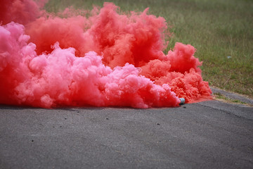 colorful pink smoke bombs in action