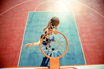 High angle view of basketball player dunking basketball in hoop