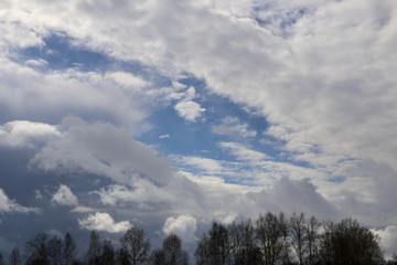 Spring. blue sky with fluffy white clouds. sun, sunlight, clouds, sky - spring changeable weather.
