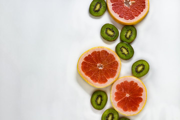 Cut fresh fruit, kiwi and grapefruit on a white background