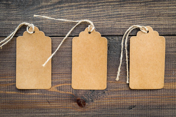 Figured blank tags for write price or discount on dark wooden background mockup pattern