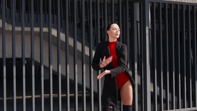 Sexy female dancer in Vogue and Waacking dance style dancing in the city with urban background.