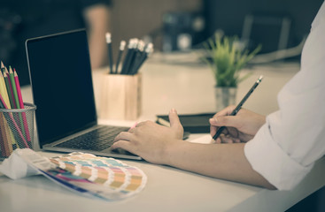 Cropped image of businessman working at office with laptop and document on desk