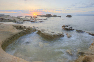 Morning scenery of a beautiful rocky beach under moody sky at Yehliu Coast, Taipei, Taiwan ~ A fascinating sunrise scenery of Yehliu Geopark under dramatic dawning sky (Long Exposure)