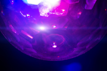 Colorful blurred abstraction of a disco luminous ball.