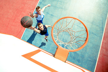 High angle view of basketball player dunking basketball in hoop