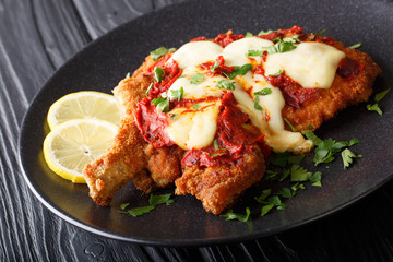 South American food: Milanesa napolitana Beef cutlet in breadcrumbs with mozzarella cheese and...