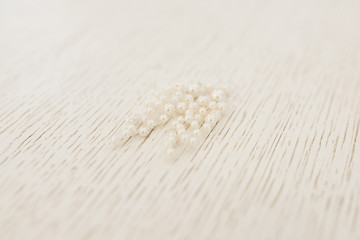 Women's wedding earrings on a light background, selective focus