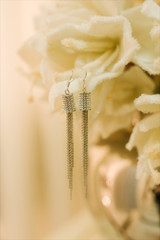 Women's wedding jewelry (earrings) on a flower, selective focus