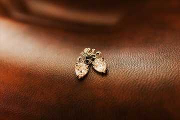 Women's wedding earrings on a dark background, selective focus