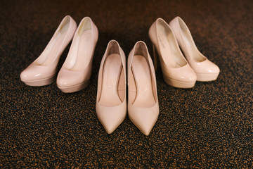 Women's wedding shoes and bridesmaid shoes on dark background, bride fees, selective focus