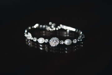 Women's wedding jewelry (bracelet) on black background, selective focus