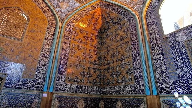 ISFAHAN, IRAN - OCTOBER 21, 2017: Interior of Sheikh Lotfollah mosque with rich Islamic patterns on walls, Arabic calligraphy on glazed tiles and outstanding dome, on October 21 in Isfahan.