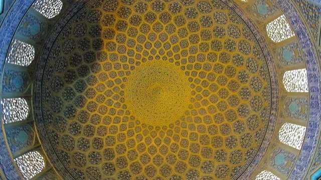 ISFAHAN, IRAN - OCTOBER 21, 2017: Rotating dome of Sheikh Lotfollah mosque, decorated with tiled arabesque patterns, calligraphic belts and arched windows, on October 21 in Isfahan.