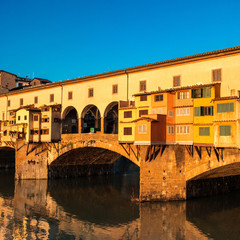 Fototapeta na wymiar Florence, Italy - Ponte Vecchio over Arno River at sunset. Florence is a popular tourist destination of Europe. .