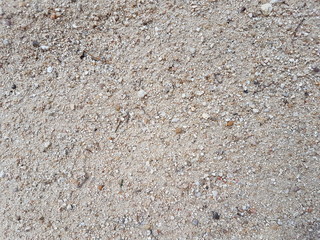 Fondo de arena close-up, piedras pequeñas sobre la arena