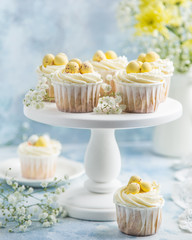Easter cupcakes decorated with cream cheese frosting and candy eggs