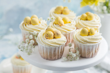 Easter cupcakes decorated with cream cheese frosting and candy eggs